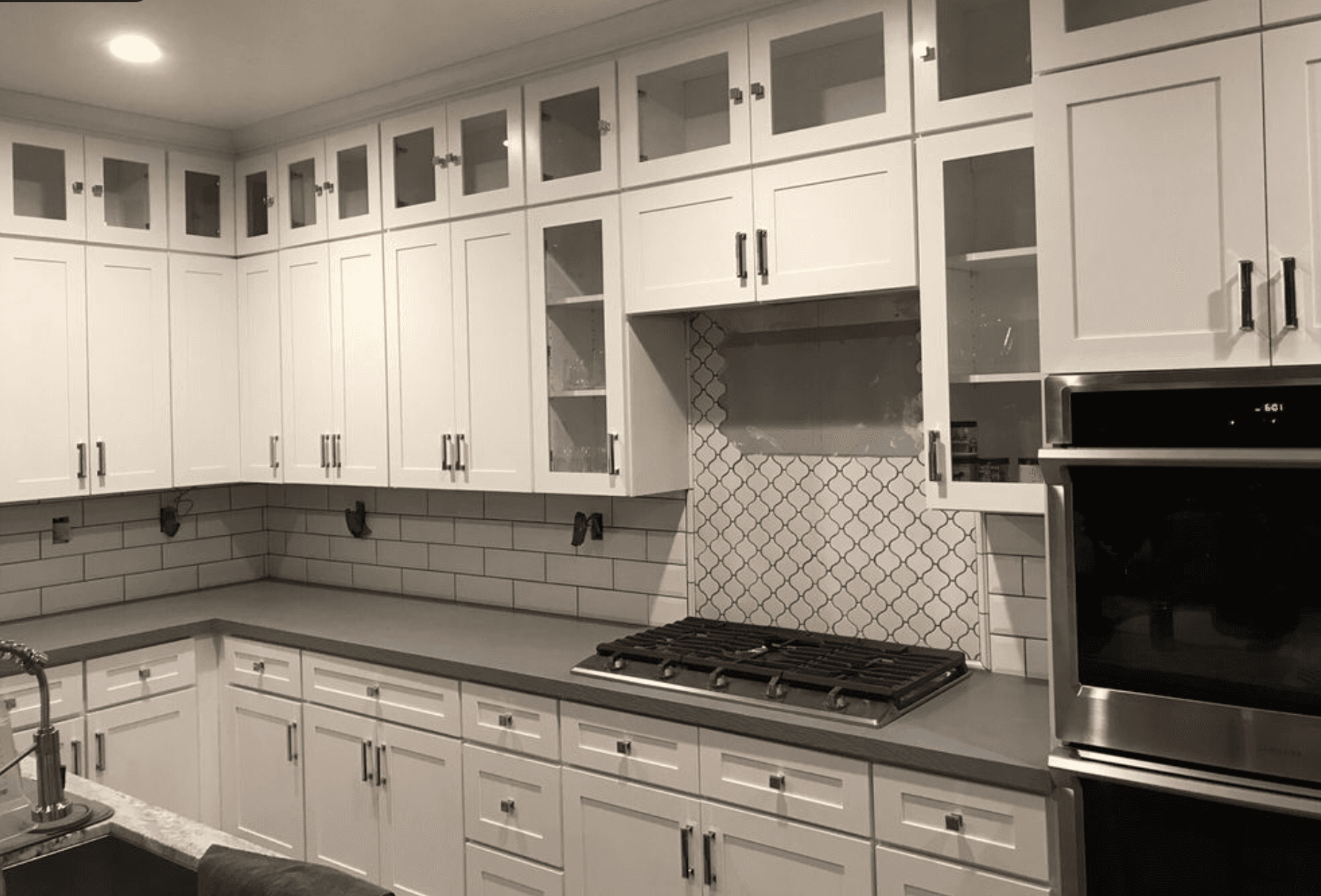 Kitchen backsplash and cabinet finish work by J & H Flooring
